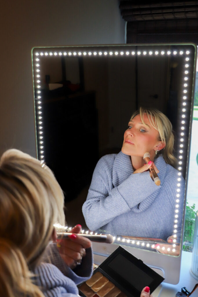 Carrie Ilott using a Seint Makeup brush to apply foundation